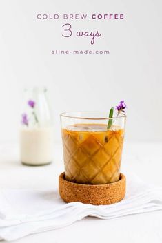 a glass filled with liquid sitting on top of a table