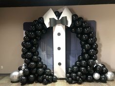 black and white balloons are arranged in the shape of a tuxedo