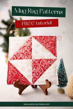 a red and white quilted mug rug with bottlebrush trees Quilt Mug Rugs Patterns Free, Christmas Rug Mugs, Free Christmas Mug Rug Patterns, Mug Rug Tutorial Quilted, Christmas Mug Rugs Patterns Free How To Make, Free Mug Rug Patterns Tutorials, Quilted Christmas Mug Rug Patterns Free, Holiday Mug Rugs, Christmas Quilted Coasters