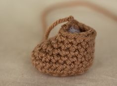 a small crocheted purse sitting on top of a table