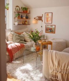 a living room filled with lots of furniture and decor on top of a white rug