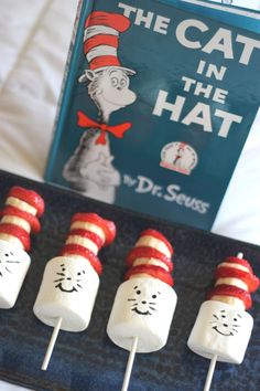 the cat in the hat marshmallows are arranged on a tray next to a book