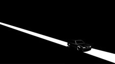 a black and white photo of a car driving down the road at night with its headlights on