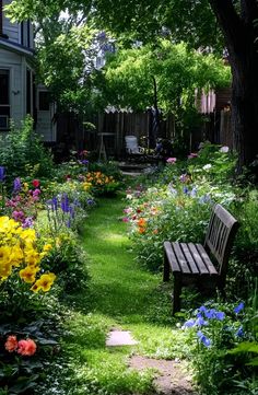 a wooden bench sitting in the middle of a lush green yard filled with flowers and trees