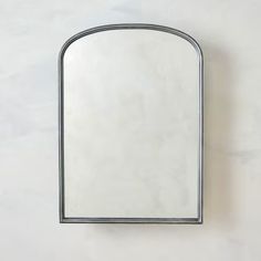 a mirror mounted to the side of a wall