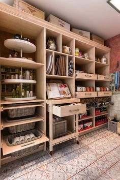 a kitchen with lots of wooden shelves and drawers