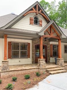 a house with wood trim and shutters on the front