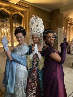 three women dressed in costume posing for the camera