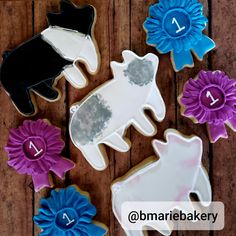 decorated cookies are arranged on a wooden table