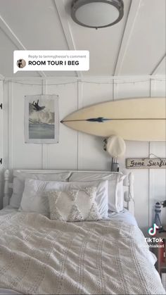 a bedroom with a surfboard mounted to the wall above it's headboard