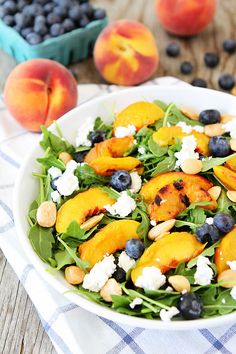 two pictures of a salad with peaches and blueberries