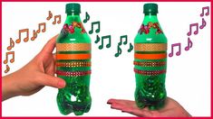 two green bottles with music notes on them and one has an orange band around it