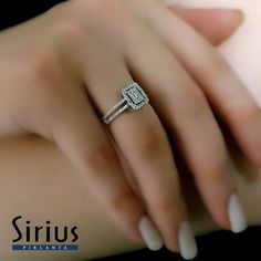 a woman's hand with two diamond rings on it