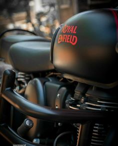 the royal enfield motorcycle is parked on the street