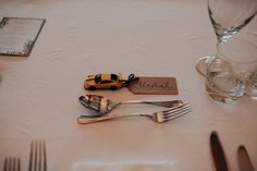 the table is set with silverware and place settings