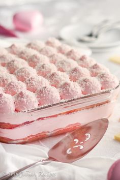 a cake with pink icing and powdered sugar on top