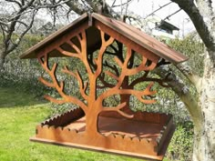 a wooden bird feeder in the shape of a tree