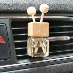 two wooden sticks sticking out of the air vent in a car's dash board