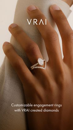 a woman's hand with a diamond ring on it and the text vrai