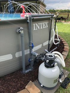 an intex tank is connected to the side of a house with water coming out of it