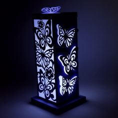 a lit up box with butterflies on it