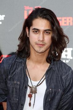 a young man with long hair wearing a necklace