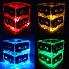 four glowing cubes in different colors and sizes, all lit up with lights on them