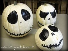 three pumpkins with faces painted on them