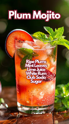 a close up of a drink in a glass on top of a table with leaves