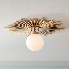 a ceiling light that has been designed to look like a sunburst on the ceiling