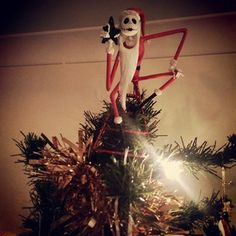 a decorated christmas tree with a skeleton on top