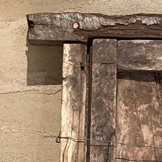 a bird perched on top of a wooden window sill