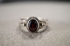 I am offering you this vintage sterling silver wedding band stacker design ring.  This features a raised relief single stone setting with beautiful detailing.  This has a bezel set oval shaped genuine Garnet stone set in it.  This ring is currently a size 9 3/4, though I am sure it could be sized up or down. Please review all of my pictures, as they are all a very important part of , my listing/descriptions. Vintage Engraved Stackable Round Ring, Vintage Oval Cabochon Ring With Bezel Setting, Vintage Stackable Rings For Formal Occasions, Vintage Stackable Engraved Ring For Anniversary, Victorian Oval Birthstone Wedding Ring, Oval Hallmarked Stackable Rings For Anniversary, Silver Oval Engraved Ring With Stone Setting, Silver Oval Heirloom Birthstone Ring, Certified Oval Stackable Rings For Anniversary