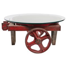 a red wagon wheel coffee table with glass top