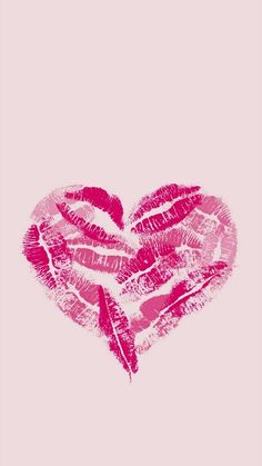 a pink heart made out of lipstick on a pink background