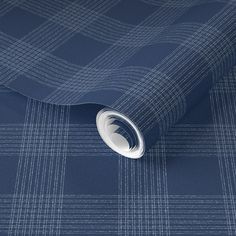 a blue plaid wallpaper with white lines on the bottom and sides, in an abstract pattern