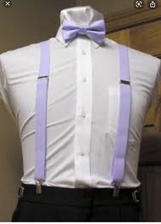 a white shirt with purple suspenders and a bow tie