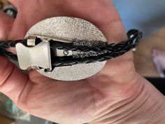 This awesome bolo tie has a vintage cowboy print with a clear resin coating and metal backing. Handmade in our shop! The cord is black and genuine leather. Our bolos pair nicely with many of our belt buckles! They make wonderful gifts. The western bolo tie rope length is 39' ; pendant size is 1 1/2'' x 1 1/4'' Black Adjustable Bolo Ties For Rodeo, Adjustable Black Bolo Ties For Rodeo, Adjustable Black Bolo Tie For Rodeo, Western Black Bolo Tie With Adjustable Length, Black Western Bolo Tie With Adjustable Length, Black Western Bolo Tie With Concho, Western Style Black Bolo Tie With Adjustable Length, Black Bolo Tie With Adjustable Cord As Gift, Black Adjustable Bolo Tie