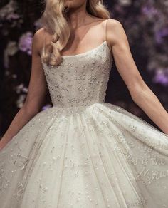 a model walks down the runway in a wedding dress