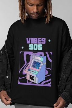 Step back in time with this 90s Retro Arcade T-shirt, designed for those who love the nostalgic vibes of old-school gaming. Featuring a vaporwave aesthetic with soft pastel tones, this graphic tee brings back the golden days of arcade machines and pixel art. Perfect for gamers, 90s kids, and anyone who appreciates the unique, playful style of the decade. This unisex shirt is comfortable, durable, and ideal for pairing with your favorite streetwear or casual look. Whether you're attending a gamin Gaming Convention, Arcade Aesthetic, Nostalgic Vibes, Playful Style, Golden Days, Aesthetic Shirt, Retro Arcade, Vaporwave Aesthetic, Retro Tee