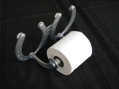 a toilet paper holder with two rolls of toilet paper hanging from it's sides