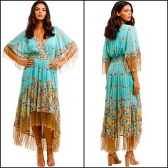 Channel Your Inner Bohemian With The Hendrix Tasseled Dress By Spell! This Beautiful Midi Is Crafted In A Striking Floral Print With A Gold Metallic Thread To Add A Bit Of Glamour. Featuring A V-Neckline, A Flattering Waistband, And A High Low Hem Finished With Feathery Tassels. Hire For Your Next Festival Or Sunset Soiree! * Lined At Bodice * Tiered Skirt * Short Sleeves Finished With Tassels Style This Dazzling Dress With A Wide Strap Sandal And An Oversized Pair Of Sunglasses! Finish The Look With A Relaxed Updo And Minimal Glowy Makeup. Brand New With Tags 49% Organic Cotton, 48% Viscose, 3% Metallic | Lining: 100% Viscose Colours: Multi, Print Recommended For: Daytime Event, Tasseled Dress, Relaxed Updo, Sunset Soiree, Crochet Midi Dress, Horse Dress, Dazzling Dress, Strappy Maxi Dress, Mumu Dress, Tassel Dress