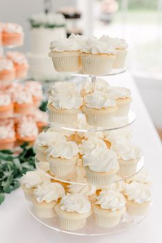 cupcakes are stacked on top of each other in the shape of a tower