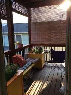 the sun shines through the blinds on this porch