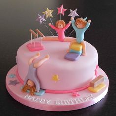 a pink birthday cake with three children on top