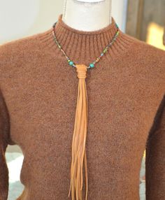 "This long leather fringe necklace is strung with Dakota Stones Mardi Gras Impression Jasper beads and turquoise. The extra long tan fringe makes this piece a standout!  Necklace measures approx. 20\" flat Necklace (without pendant) measures 18\" Fringe hangs approx. 11 1/2\" Sterling Silver Toggle Clasp 4mm Mardi Gras fancy mosaic jasper (natural), 8mm round turquoise, 4mm turquoise roundels, silver tone connector.   Gemstone Metaphysical properties:  Impression jasper is used to find clarity a Adjustable Tassel Necklace With Fringe For Festivals, Brown Tassel Necklace For Festival, Adjustable Fringe Tassel Necklace For Festival, Bohemian Adjustable Tassel Necklace With Fringe, Fringe Long Necklace Gift, Bohemian Long Tassel Necklace With Fringe, Bohemian Long Fringe Tassel Necklace, Adjustable Fringe Dangle Necklace, Adjustable Long Metal Tassel Necklace