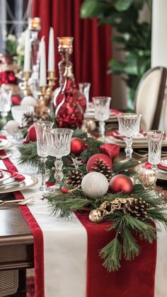 a dining room table decorated for christmas with pine cones and ornaments on the place setting