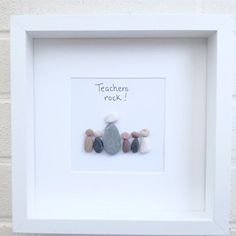 a white frame with rocks in it and the words teachers rock written on it underneath