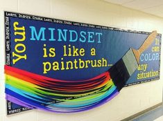 a bulletin board with a paintbrush painted on it and the words you mindset is like a rainbow