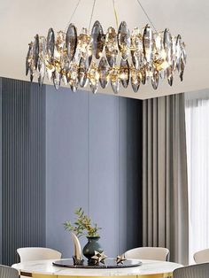 a dining room table with chairs and a chandelier hanging from it's ceiling